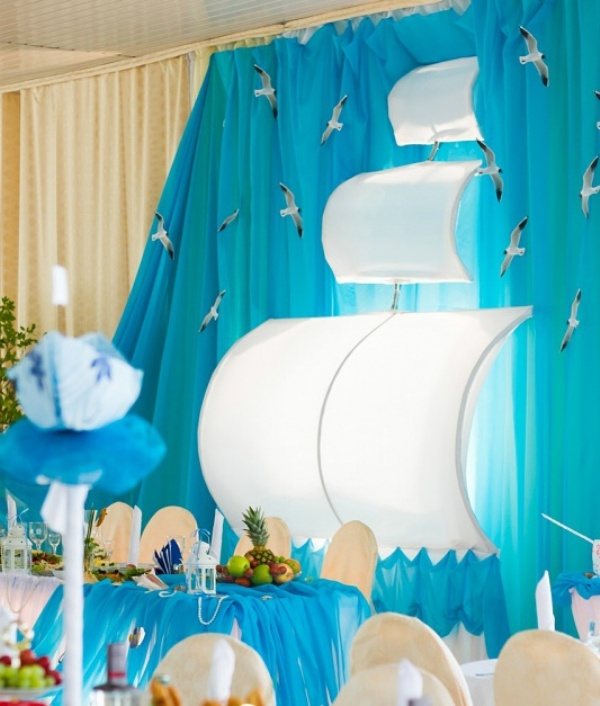 При помощи драпировки стен можно подчеркнуть стиль свадьбы. К примеру, из ткани можно сделать паруса для «морской» свадьбы.